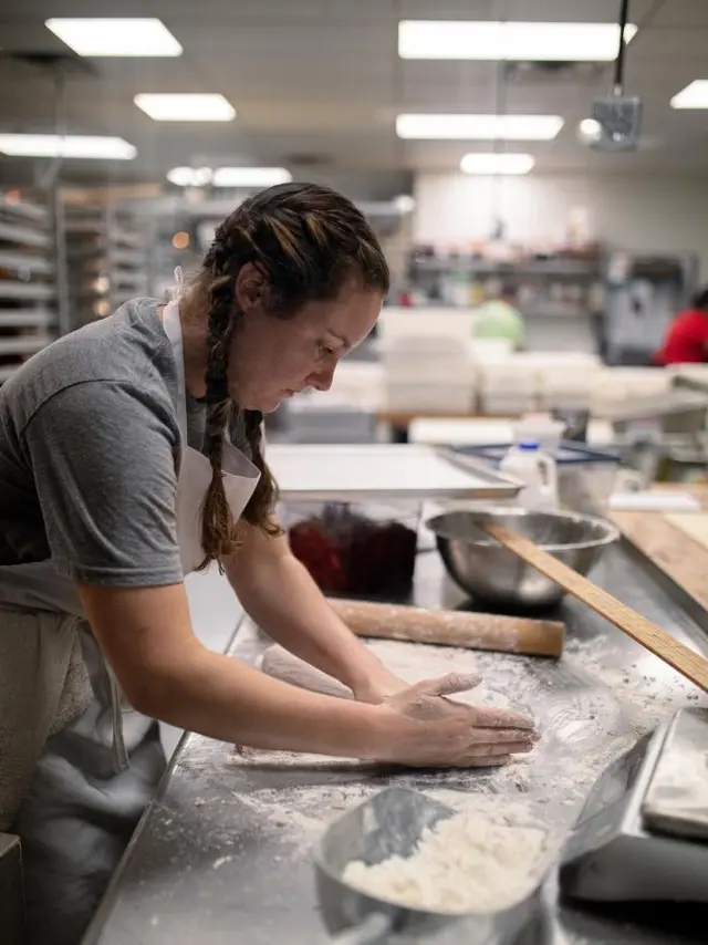 woman in braids making bread