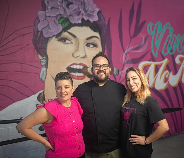 The Guava Tree owners in front of the Viva McKinney mural