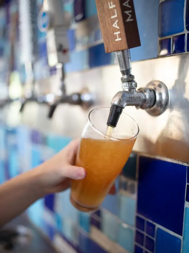 Square Burger - hand pouring draft beer into glass
