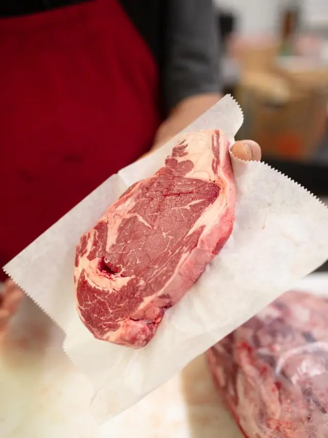 Piece of raw beef on a sheet of waxed paper
