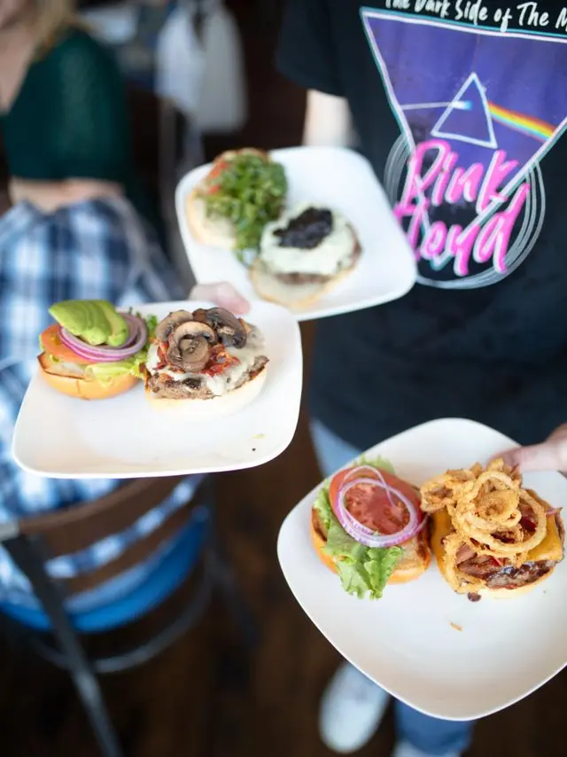 Square Burger - person holding plates of food