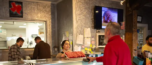 Local Yocal Farm to Market - customer buying steaks at meat counter