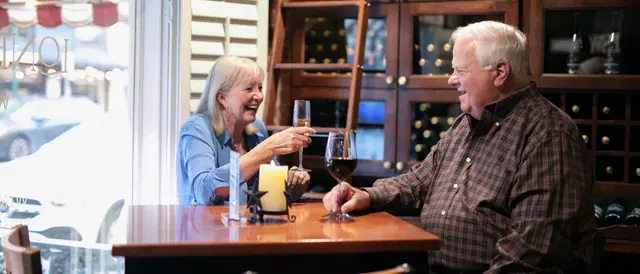 Senior couple sitting at a table in the winery