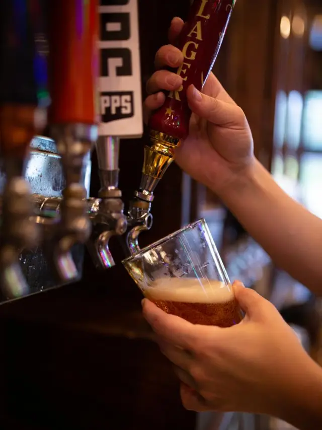 The Pub - hands pouring a draft beer