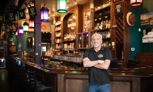 The Pub - owner standing in front of bar