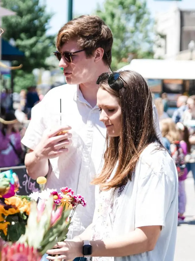 A couple with flowers at Arts in Bloom