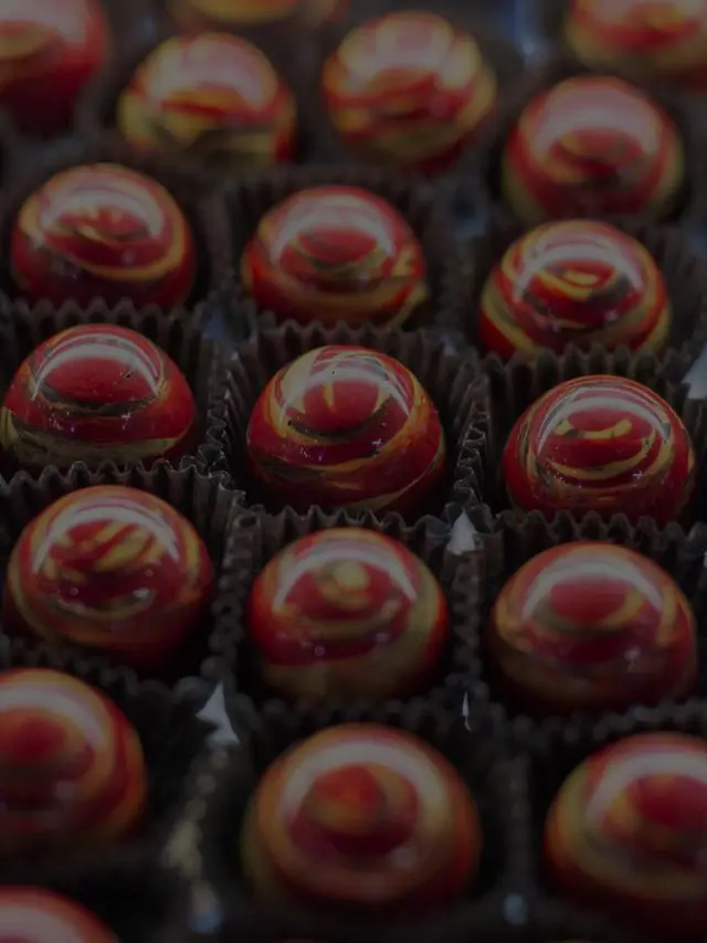 red truffle candies with yellow swirls on top