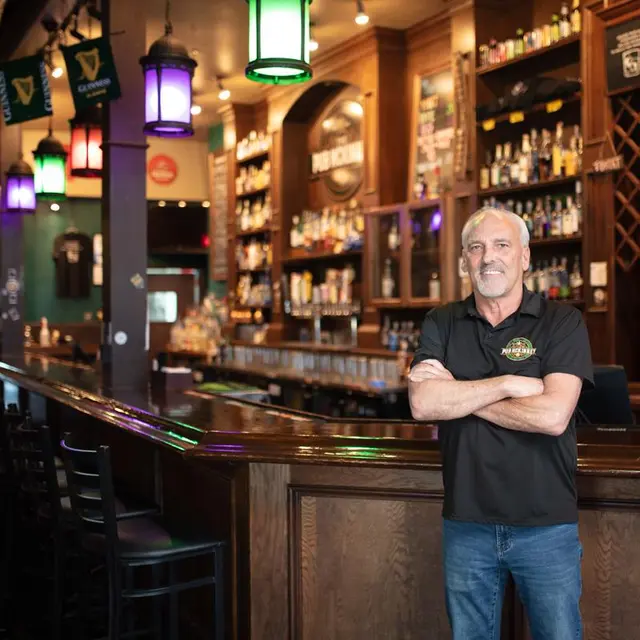 The Pub - owner standing in front of bar