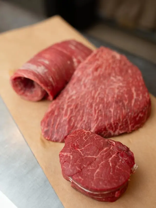 three cuts of raw beef sitting on butcher paper
