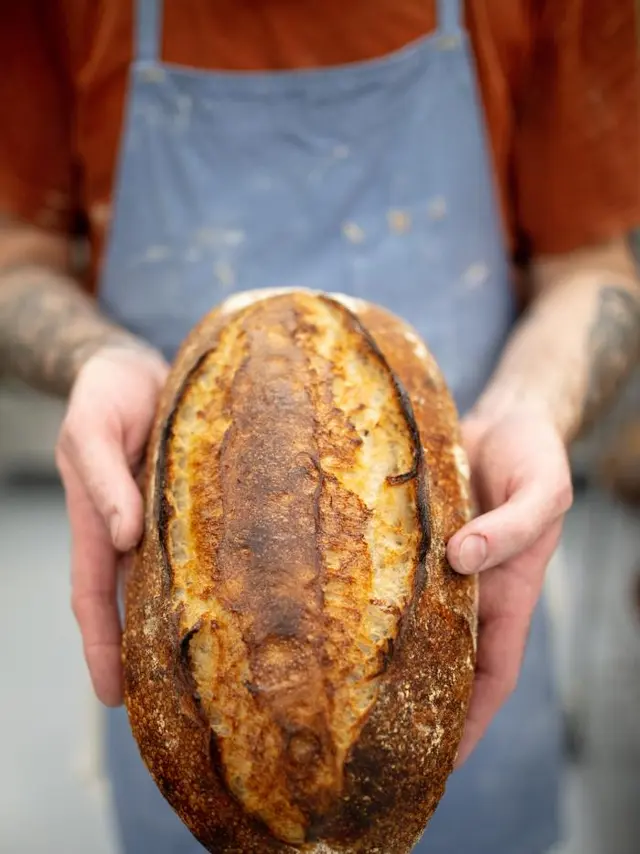 hands holding a loaf of Bresnan bread