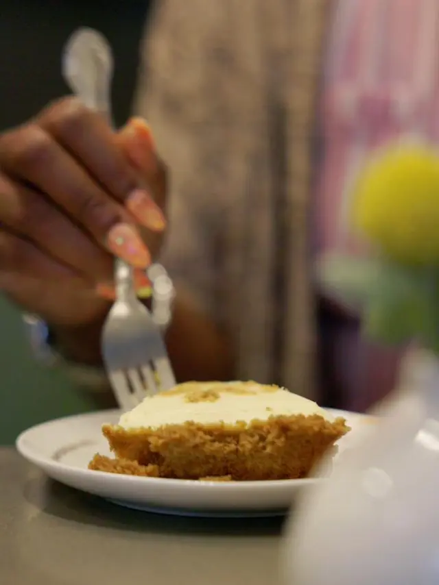 a hand holding a fork ready to eat a piece of pie